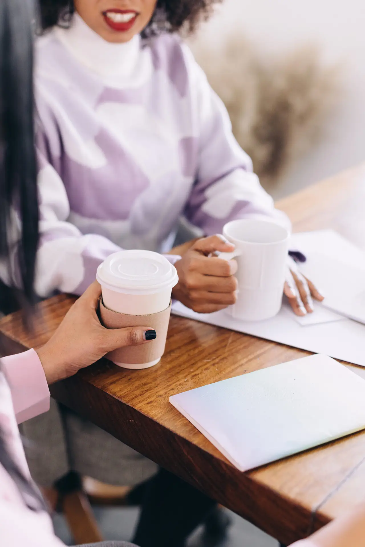 Two women sitting at a table working together